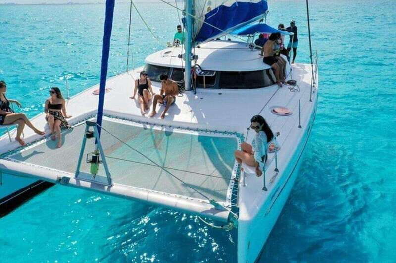 Isla Mujeres Plus Experience Catamaran Tour + Snorkel+Lunch - The Return Cruise at Sunset and the Spinnaker If Conditions Allow